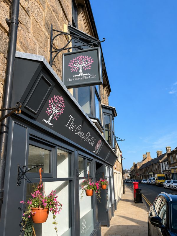 Custom projecting swing sign designed and installed for a cafe in Wooler, Northumberland