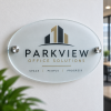 Oval frosted acrylic stand-off sign with chrome wall fixings